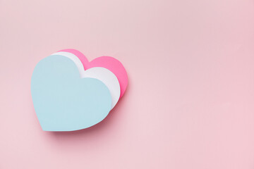 Paper hearts on color background. Concept of transgender