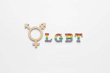 Symbol of transgender and abbreviation LGBT on white background