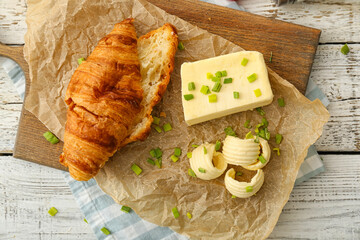 Composition with croissant and butter on light wooden background - obrazy, fototapety, plakaty