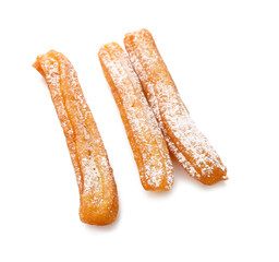 Tasty churros on white background