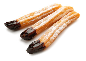 Tasty churros dipped in chocolate on white background