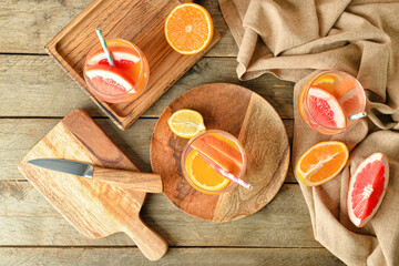 Glasses of tasty lemonade on wooden background