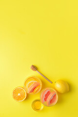 Composition with tasty cold lemonade and ingredients on color background