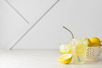 Glass of tasty cold lemonade on table