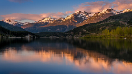 Sunset creating an Orange Sky over the Garibaldi Range and the Mountains Reflecting on the smooth...