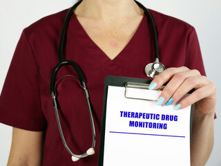 Medical concept meaning THERAPEUTIC DRUG MONITORING with inscription on the sheet.