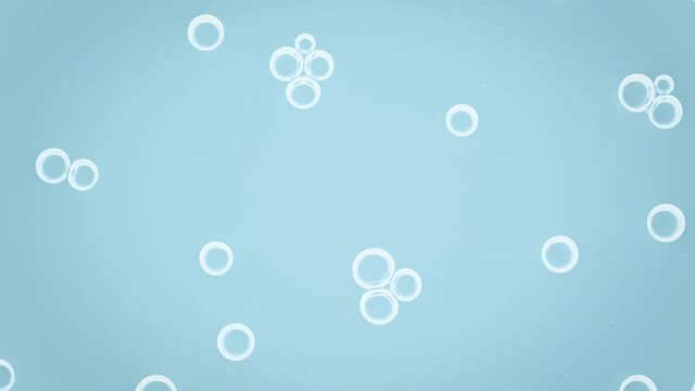 White small soap bubbles attract each other moving spontaneously and creating bubble clusters against pale blue background | Shot of body care cosmetics ingredients for its advertising