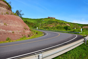 Beautiful long road on the mountain summer day and bright blue sky