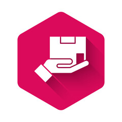 White Delivery insurance icon isolated with long shadow. Insured cardboard boxes beyond the shield. Pink hexagon button. Vector.