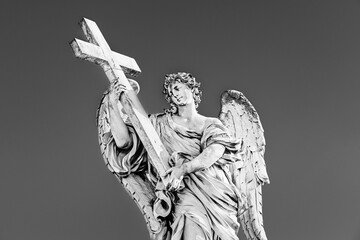Medieval outdoor statue of an Angel with the Cross by Ercole Ferrata on Sant'Angelo Bridge in Rome, Lazio region, Italy