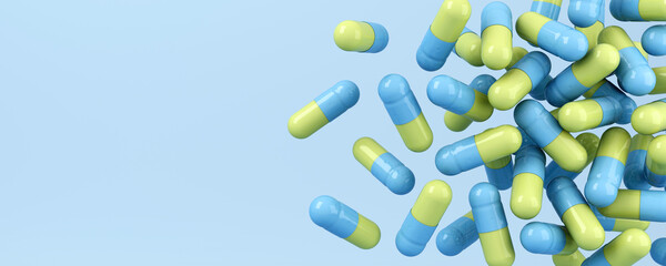 Dropped yellow and blue pills on blue background. Medical 3d illustration.