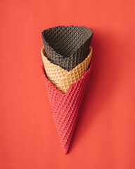 Ice cream cones on red background. Minimal summer food concept. Flat lay.