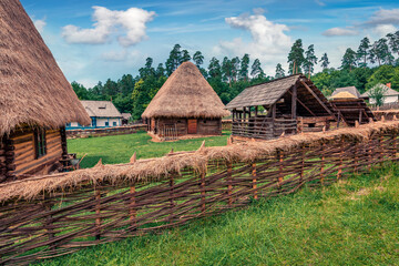 Fototapeta na wymiar Exotic summer view of traditional romanian peasant houses. Captivating rural scene of Transylvania, Romania, Europe. Beauty of countryside concept background.