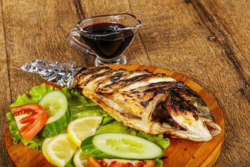 Grilled dorada fish with sauce