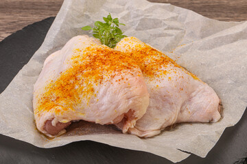 Raw chicken thigh with spices