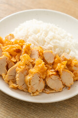 fried chicken topped rice with dipping sauce