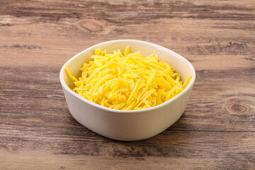 Shredded yellow cheese in the bowl