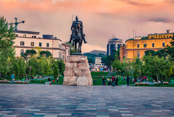 Monument of Skanderbeg in Scanderbeg Square. Colrful spring sunset in the capital of Albania -...
