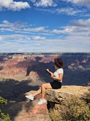 woman sitting on the rock grand canyon romantic landscape, dreaming on the top of the rock woman on...