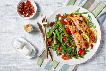 grilled salmon fillets with lemon, bacon,vegetables