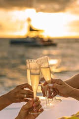 Hand holding a glass drinking wine on Sunset sea background. - 436149781
