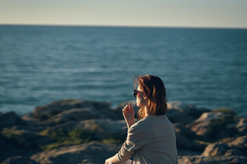 woman by the river in the mountains in nature beach summer landscape fresh air