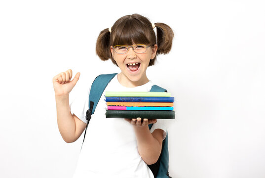 Little Girl With Blue Back Pack Holding Books, Isolated On White