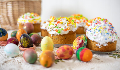 Easter cakes with Easter eggs on a vintage tablecloth, preparation for the holiday.