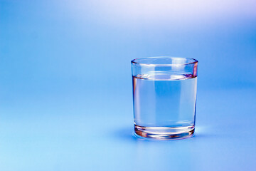 Fresh water in glass on aqua blue background. Part of set.