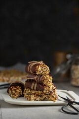 Seed, fruit and nuts vegan bars, healthy homemade raw snack dessert  on rustic table.  Studio image with copy space.