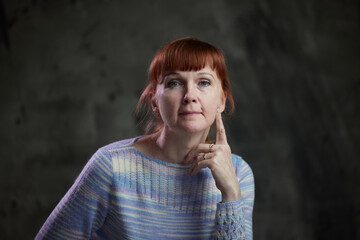 Portrait of adult Caucasian woman on gray background