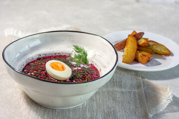 Traditional summer cold beetroot soup with baked potato wedges. Summer menu concept. Horizontal layout.