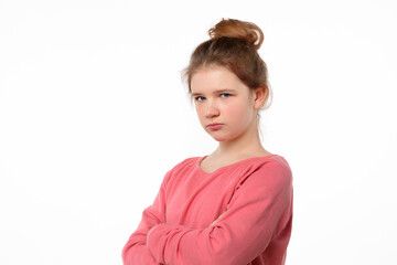 Photo of offended young girl posing isolated on white background. Holding hands crossed, looking at...