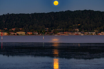 Full moon rising at the waterfront