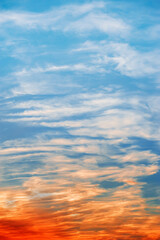 Cumulus clouds with bright illumination of sunset or dawn. Dramatic skyscape