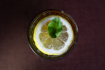 summer cocktail with lemon and mint on a dark background top view