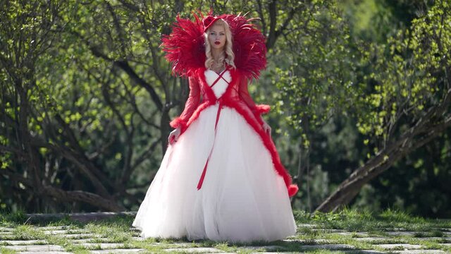 fabulous queen dressed gorgeous gown is walking at nature in royal garden, fantasy portrait