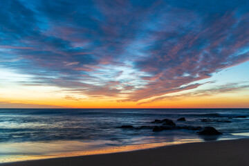 Sunrise at the beach with high cloud