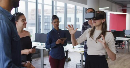 Diverse group of business colleagues using vr headset during meeting - Powered by Adobe