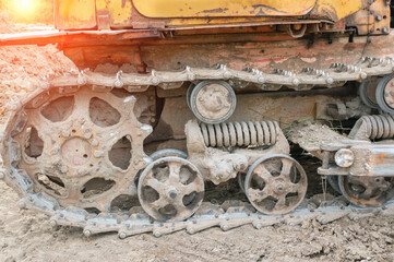 Fototapeta na wymiar Close-up of the inner undercarriage of an old excavator. Old but still working technologies today