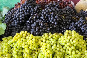 Fresh organic grapes fruit pile background