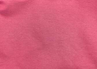 Pink jersey fabric matte texture top view. Red coral knitwear satin background. Fashion color feminine clothes trend. Female blog backdrop text sign design. Girly abstract wallpaper textile surface.