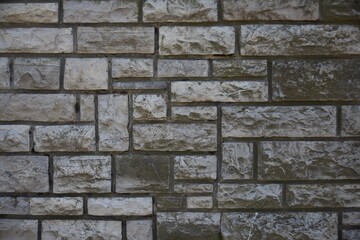 Photograph of a real wall made of natural stones. weathered wall with a wonderful geometric pattern