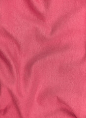 Fototapeta na wymiar Pink jersey fabric matte texture top view. Red coral knitwear satin background. Fashion color feminine clothes trend. Female blog backdrop text sign design. Girly abstract wallpaper textile surface.
