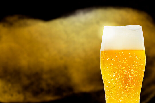 Glass of beer with a drop of water and a luxurious background image