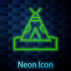 Glowing neon line Traditional indian teepee or wigwam icon isolated on brick wall background. Indian tent. Vector