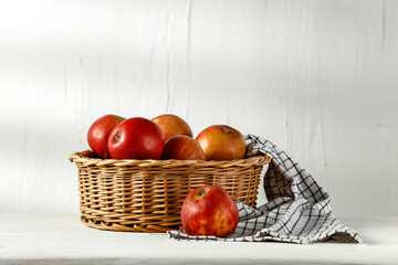 Apples on a white table in a white room and morning sun rays 