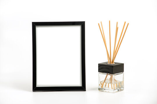 Black vertical picture frame and incense decoration on white backgrtound. Clipping path for a frame