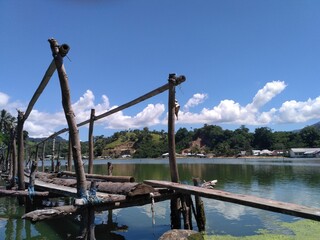 Traditional Wood bridge over the lake landscape in Indonesian 