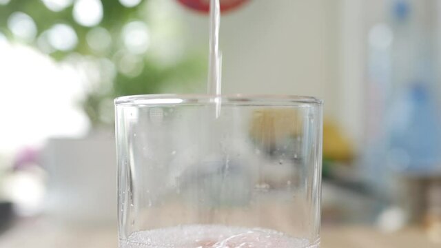 A Glass with Cold, Sweet, Acidulated, and Refreshing Grapefruit Drink. Shooting with a Glass Filled with a Fresh and Tasty Drink.